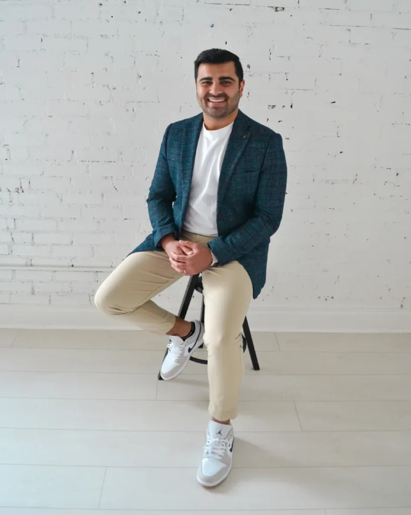 Dr. Raamis Hirani seated and smiling